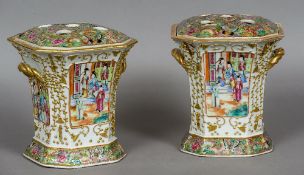 A pair of 19th century Cantonese famille rose vases
Each of twin handled canted square section form