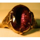 A Georgian unmarked amethyst set ring
The claw set stone above the florally engraved shoulders.