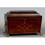 A 19th century inlaid mahogany tea caddy
Of sarcophagus form,