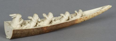 A 19th century Japanese ivory tusk carving
Formed as five rabbits rowing a boat,