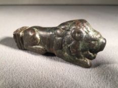 A Roman bronze key handle, circa 3rd century AD
Modelled as a crouching lion.  7.5 cm long.