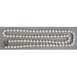 A string of baroque cultured pearls
Mounted with a sapphire set white gold clasp.  88 cm long.
