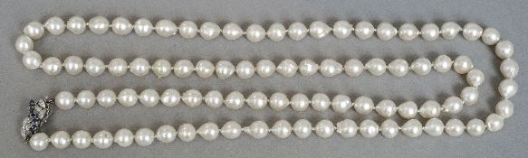 A string of baroque cultured pearls
Mounted with a sapphire set white gold clasp.  88 cm long.