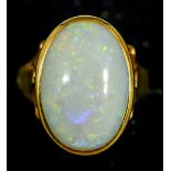 An unmarked 18 ct gold and opal ring
The cabochon stone set above the pierced shoulders.