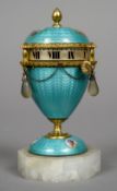 An enamel decorated unmarked silver gilt egg shaped clock
Decorated with various figural vignettes.