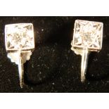 A pair of 9 ct white gold earrings
Each of square form with a screw fixing.