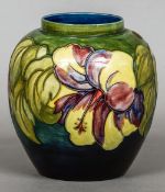 A William Moorcroft ovoid vase in the Anemone pattern
The underside with applied paper label.