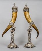 A pair of silver plate mounted horn cornucopia
Each with a removable lid and cast fruiting vine