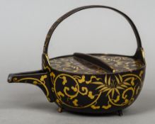 A 19th century Japanese gilt lacquered teapot
With loop handle and open spout;