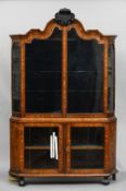 A 19th century Dutch marquetry display cabinet
The scrolling top above twin glazed doors flanked by