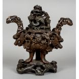 A Chinese carved soapstone censor
Carved throughout with dogs-of-fo and mythical beasts.