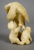 A 19th century Japanese carved ivory okimono 
Formed as an eagle attacking monkeys.  9 cm high.