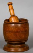 A 19th century turned elm and beech pestle and mortar
The mortar 17.5 cm high.