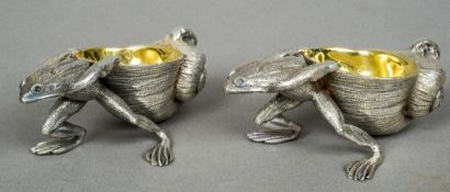 A pair of silver plate and gilded table salts
Each formed as a frog pulling a snail shell.  Each 10.