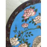 A Chinese cloisonne plate
Typically decorated with cranes in a river landscape with floral sprays.
