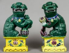 A pair of 19th century pottery dogs-of-fo
Each of typical form, with a green glaze,