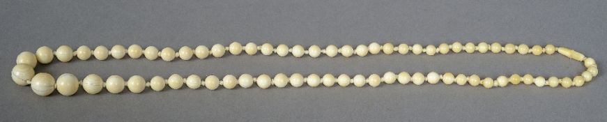 A string of ivory beads
Of varying sizes.  78 cm long.