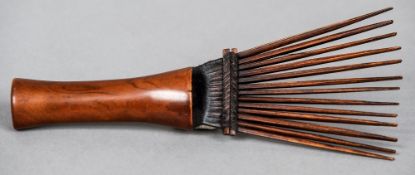 An African tribal carved wooden comb
20.5 cm long.