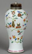 A Chinese porcelain baluster vase and cover
Decorated with applied floral sprays and precious