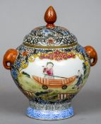 A Chinese porcelain twin handled vase and cover
The handles modelled as elephant masks,