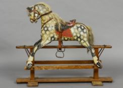 An early 20th century rocking horse
Of typical form, with dapple grey painted decoration.