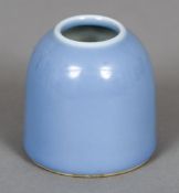 A Chinese porcelain beehive brush pot
With all over pale blue glaze,