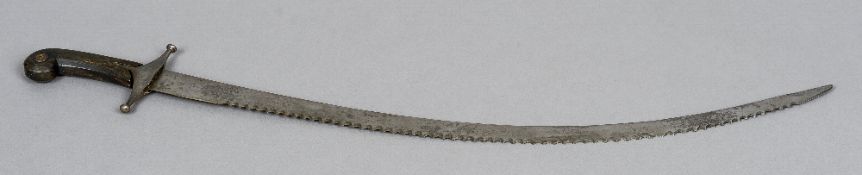 A 19th century Indian serrated sabre
With curved blade and pistol grip handle.  79 cm long.