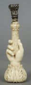 A 19th century finely carved ivory handled seal
Formed as hand with floral decoration.  10 cm high.