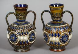 A pair of Doulton Lambeth twin handled vases
Each typically decorated,