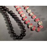 A string of Chinese coloured glass beads 
With applied floral decoration;