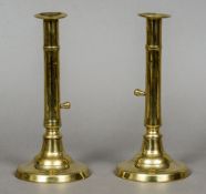 A pair of 19th century brass ejector candlesticks
Of slender form.  21.5 cm high.