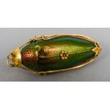 A Chinese high carat gold mounted beetle brooch
Of naturalistic form, with ruby inset eyes.  4.