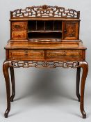 A late 19th century Chinese rosewood writing table
The pierced top rail above an arrangement of