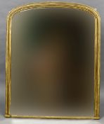 A Victorian gilt framed overmantle mirror
Of typical domed form.  Approximately 110 cm wide.