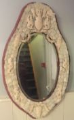 A 19th century Dieppe carved ivory wall mirror
The oval bevelled plate bordered with figural masks,