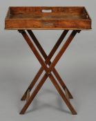 A 19th century mahogany butler's tray on stand
Of typical form.  Approximately 80 cm wide.
