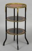 A 19th century French ebonised and amboyna three tier etergere
Of circular form,