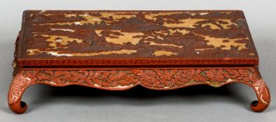 A 19th century Chinese cinnabar lacquered low tea table
Of rectangular form,