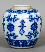 A Chinese blue and white porcelain ginger jar
Decorated with lotus sprays interspersed with archaic