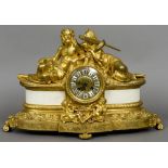 A gilt bronze mantel clock
Decorated with ancient figures and putto.  49 cm wide.