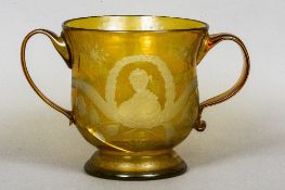 A large cut amber overlaid glass commemorative loving cup
Decorated with thistles and a portrait of