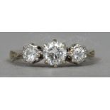 An 18 ct gold diamond three stone ring
 CONDITION REPORTS: Some inclusions,
