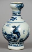 A Chinese pottery blue and white vase
Decorated with an exotic bird.  18 cm high.