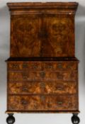 An 18th century walnut cabinet on chest
The moulded cornice above twin cupboard doors enclosing