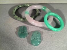 Three Chinese carved hardstone bangles
Together with two carved jade pendants.