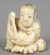 A small Chinese carved ivory group
Worked as  a boy cradling a crane.  4 cm high.