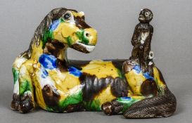 A 18th century Chinese porcelain horse and monkey group
The monkey seated on the recumbent horses