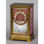 A 19th century ormolu and porcelain mantel clock
The engraved ormolu case fitted with Sevres type