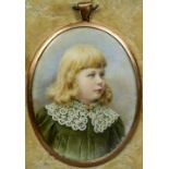 An unmarked yellow metal framed portrait miniature of a young girl
With lace collar,