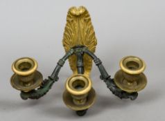 An early 19th century ormolu and patinated bronze three branch wall light
The acanthus cast ormolu